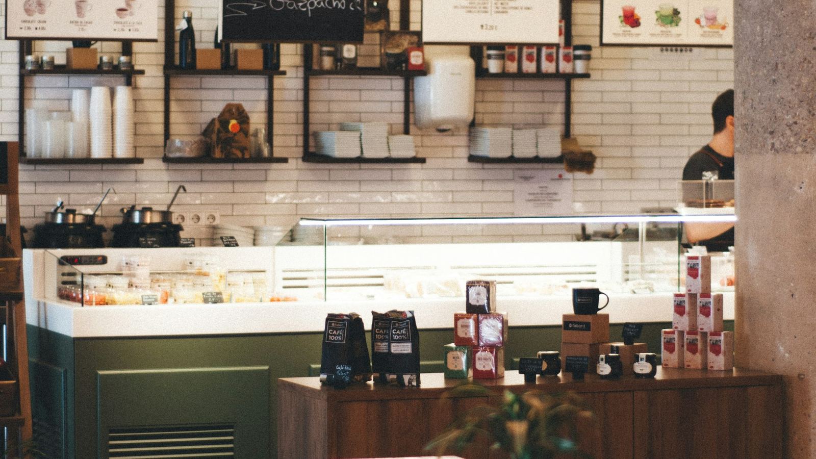 Espresso portafilters holding fresh grounds and whole beans on a counter